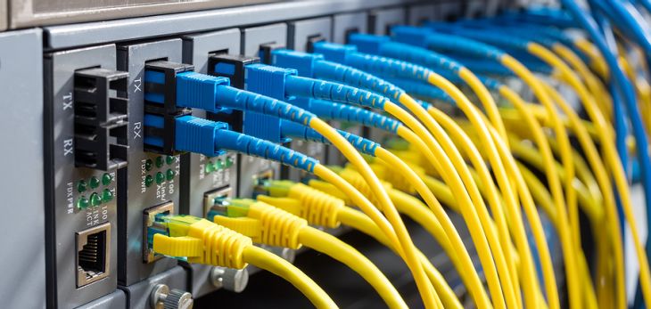 Fiber Optic cables connected to optic ports and UTP, Network cables connected to ethernet ports.